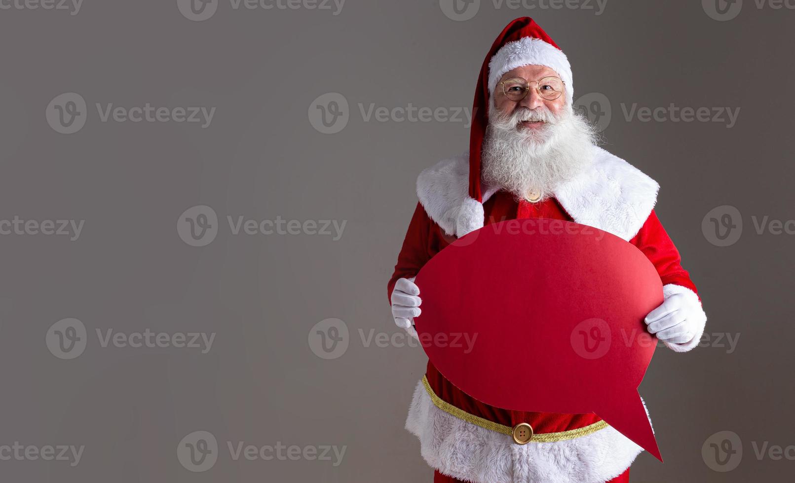 Santa Claus holding blank text balloon. photo