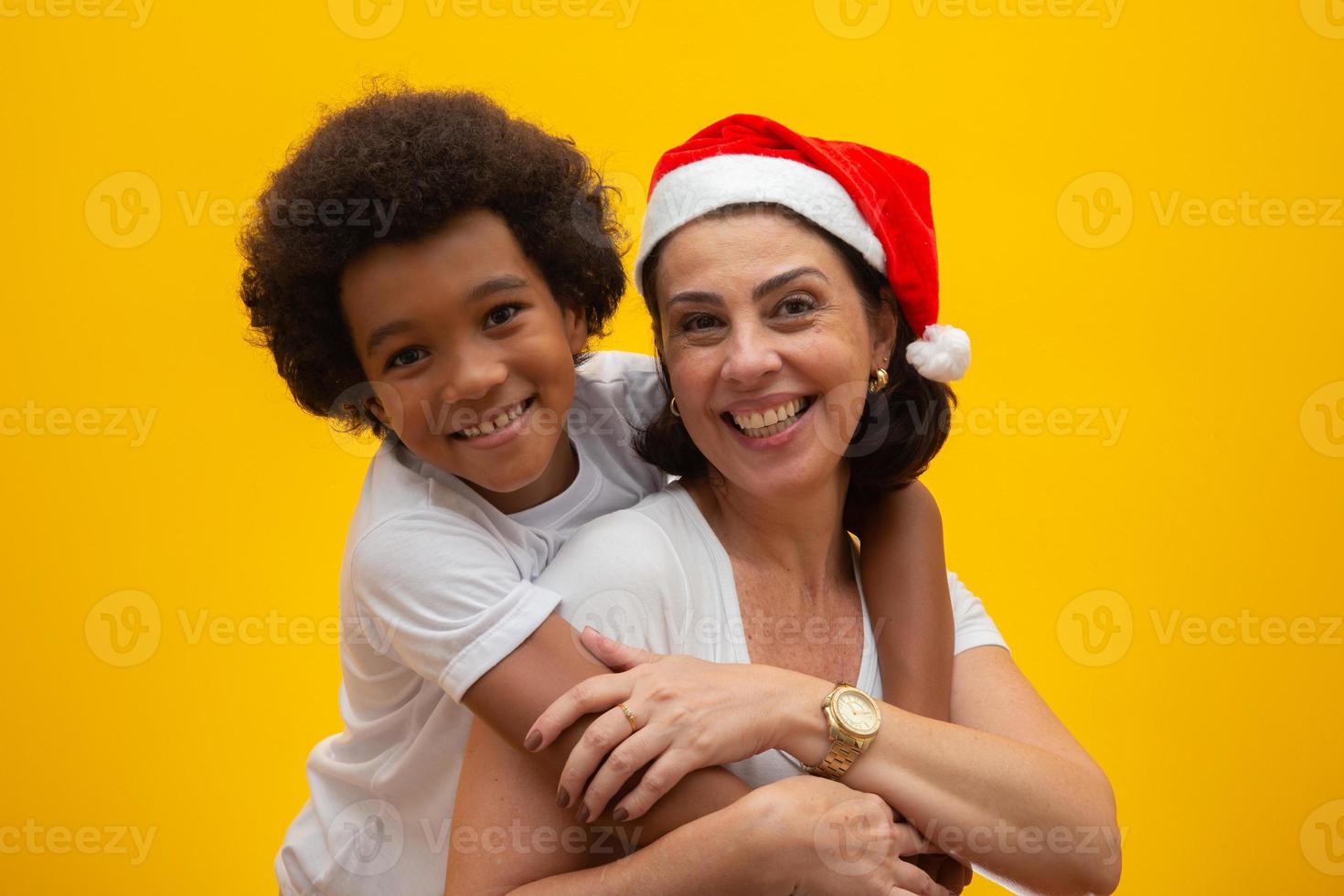 White mother with black son exchanging gifts on Christmas eve. Foster child concept. Social respect, skin color, inclusion. photo