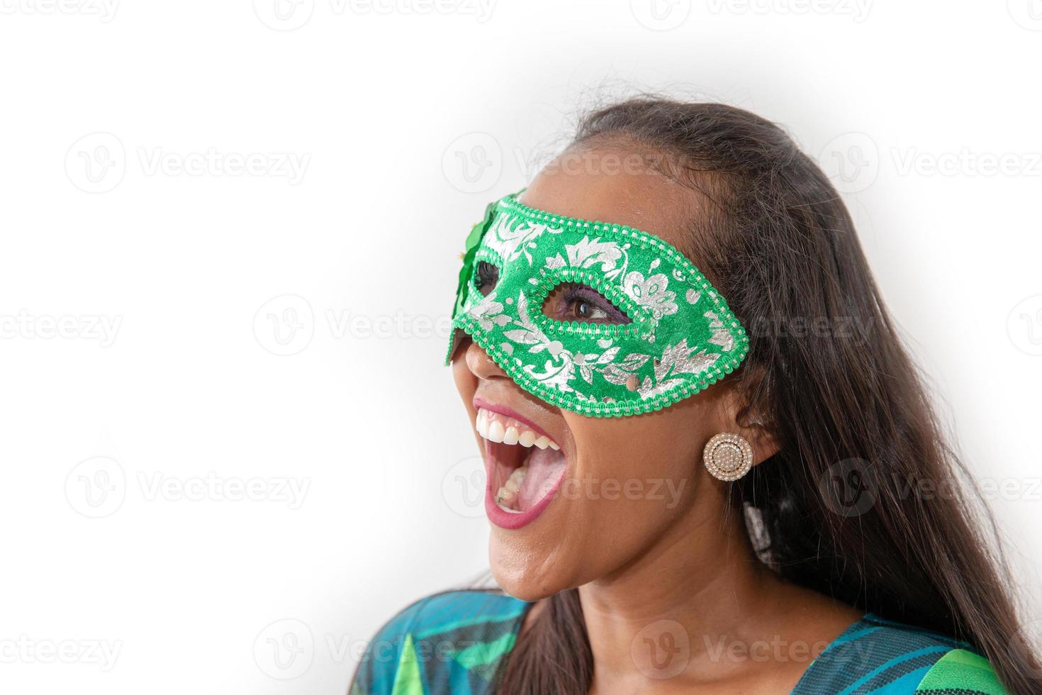 happy young woman with mask and confetti at carnaval party. Brazilian Carnival photo