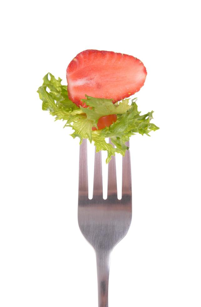 Mixed salad on fork isolated on white background photo