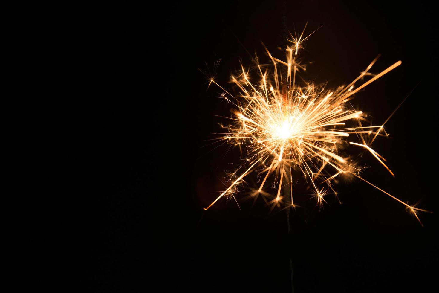 New year party sparkler on black background photo