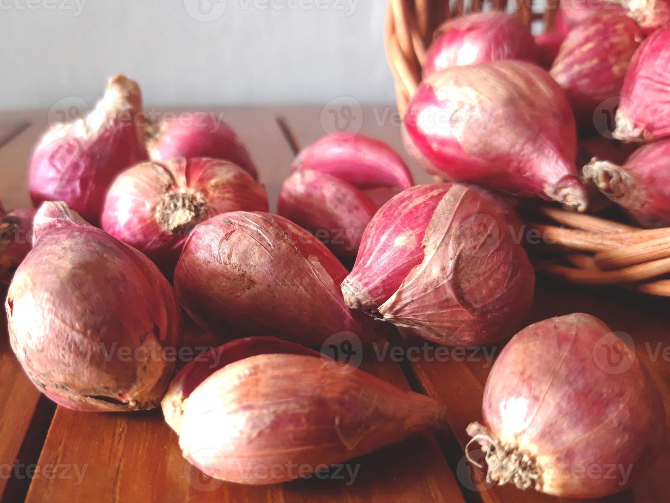 Red onions composition lying on the wooden table photo