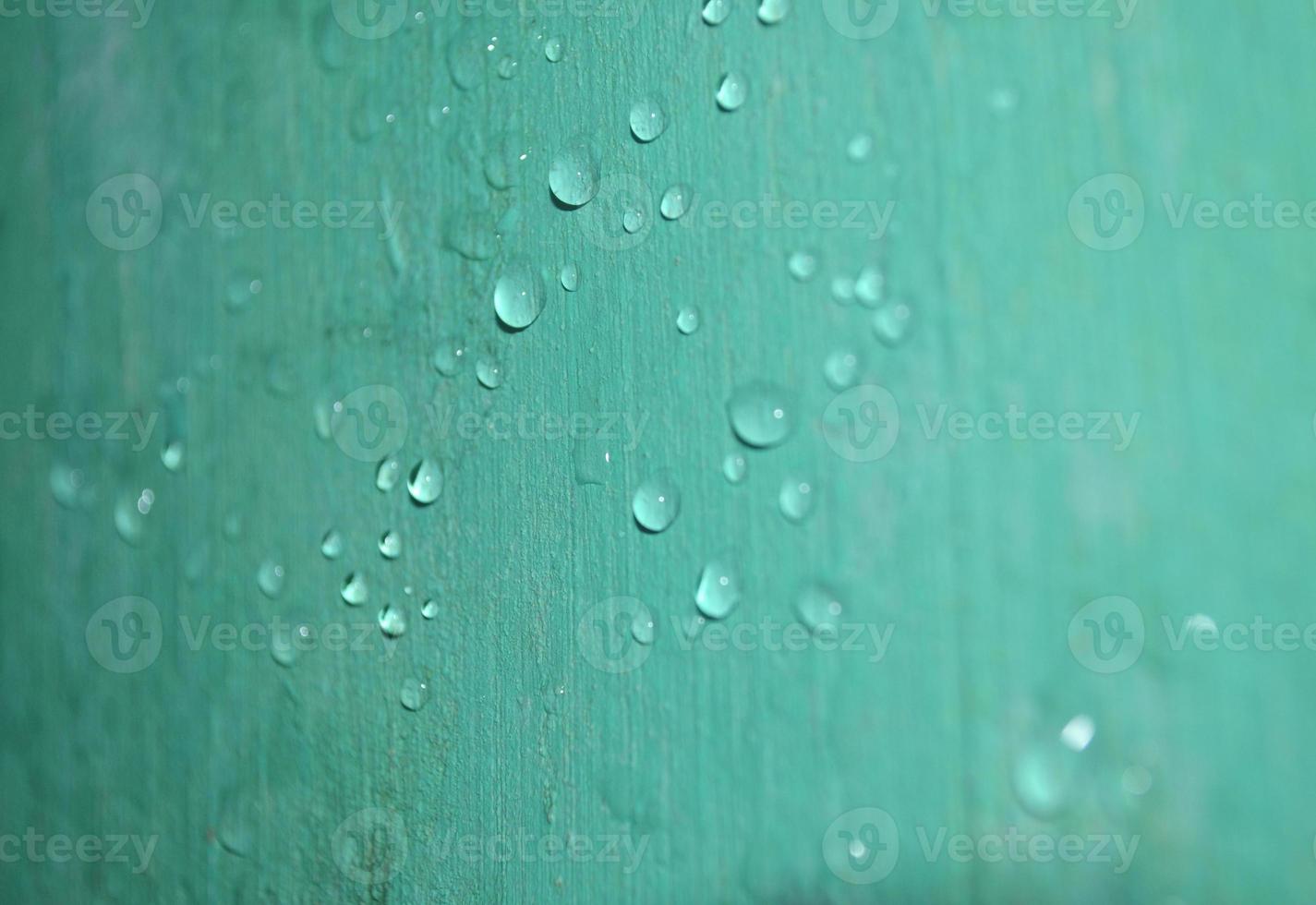 raindrop on the wall are shiny green due to the reflection photo