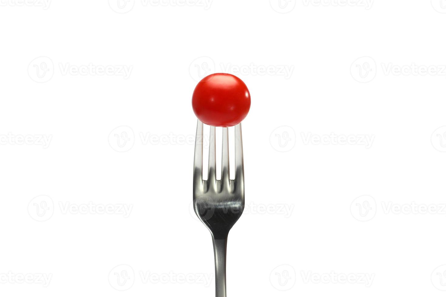 cherry tomatoes on a fork. isolated on a white background. Fork with cherry tomato close-up. Macro photo. photo