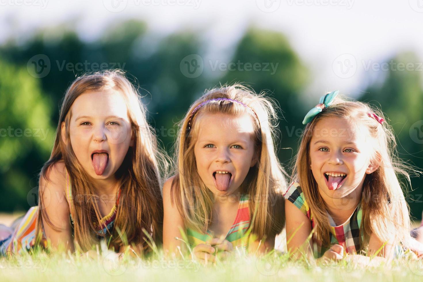 Three little girls sticking their tongues out 9367112 Stock Photo at