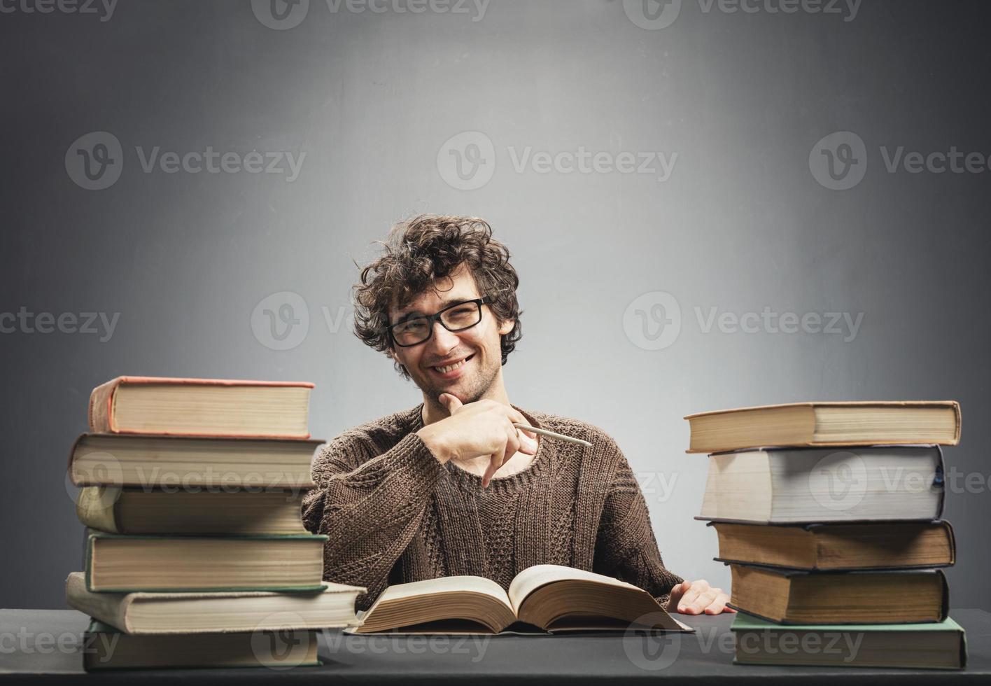 Satisfied student sitting at the desk. photo