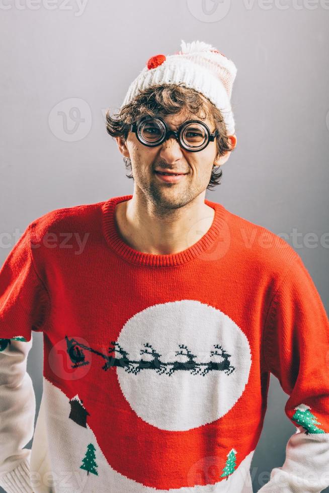 Grumpy man in funny christmas clothes and glasses. photo