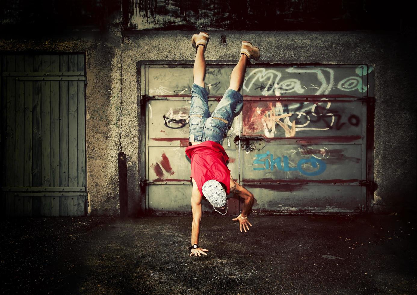 Poland, 2022 - Young man jumping on grunge wall photo