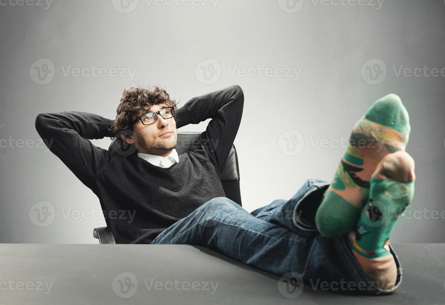 Man relaxing at desk photo