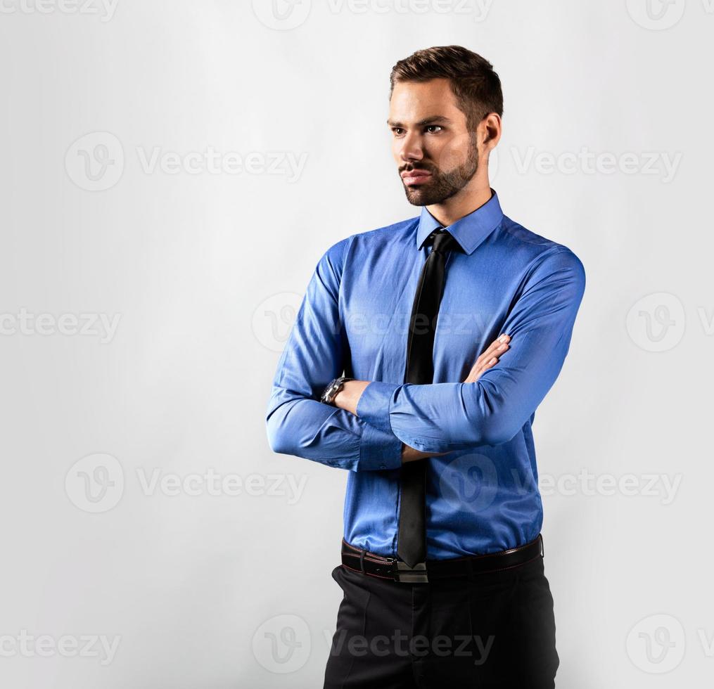 Handsome young businessman standing confident. Isolated on white photo