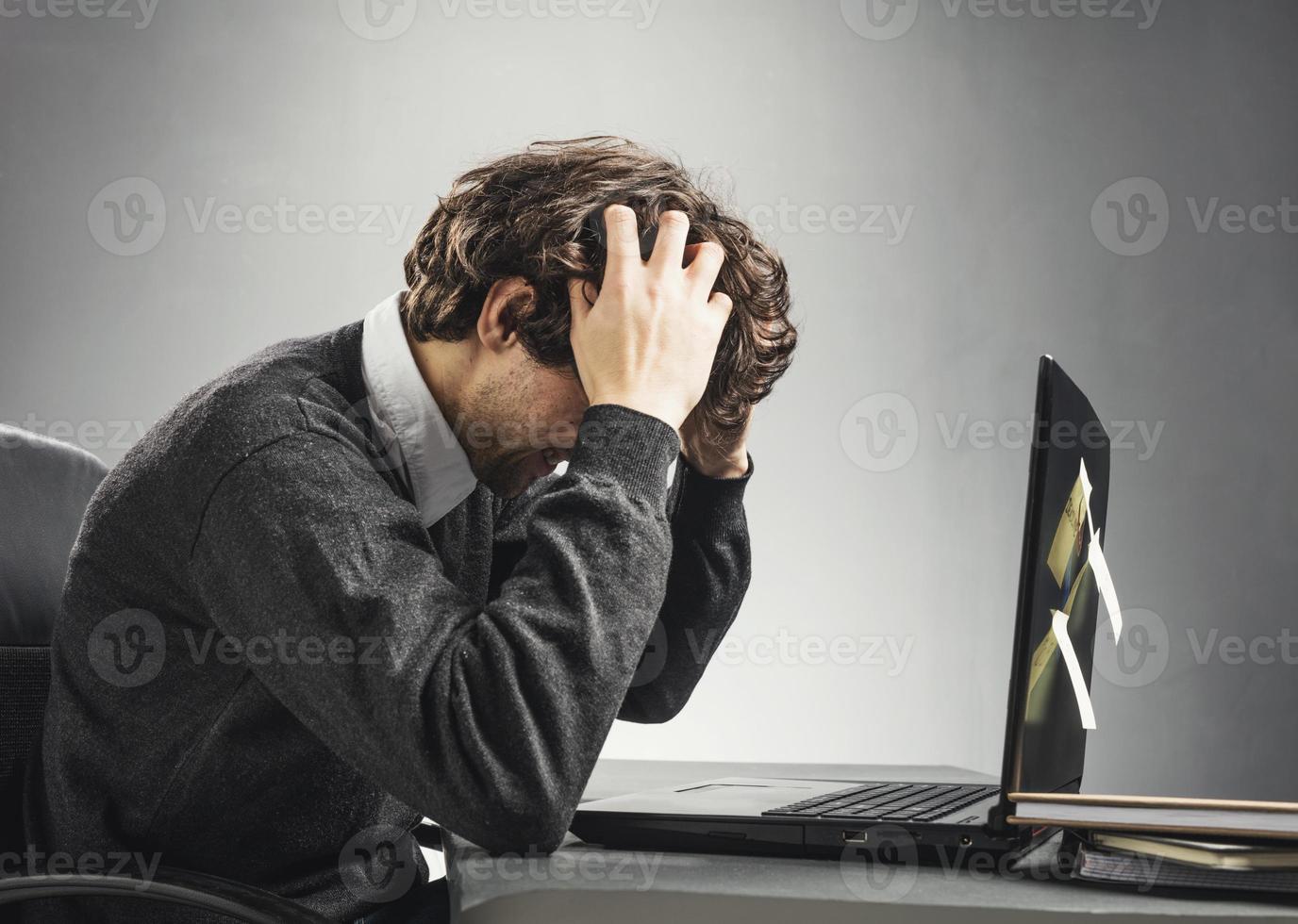 Man frustrated at work photo