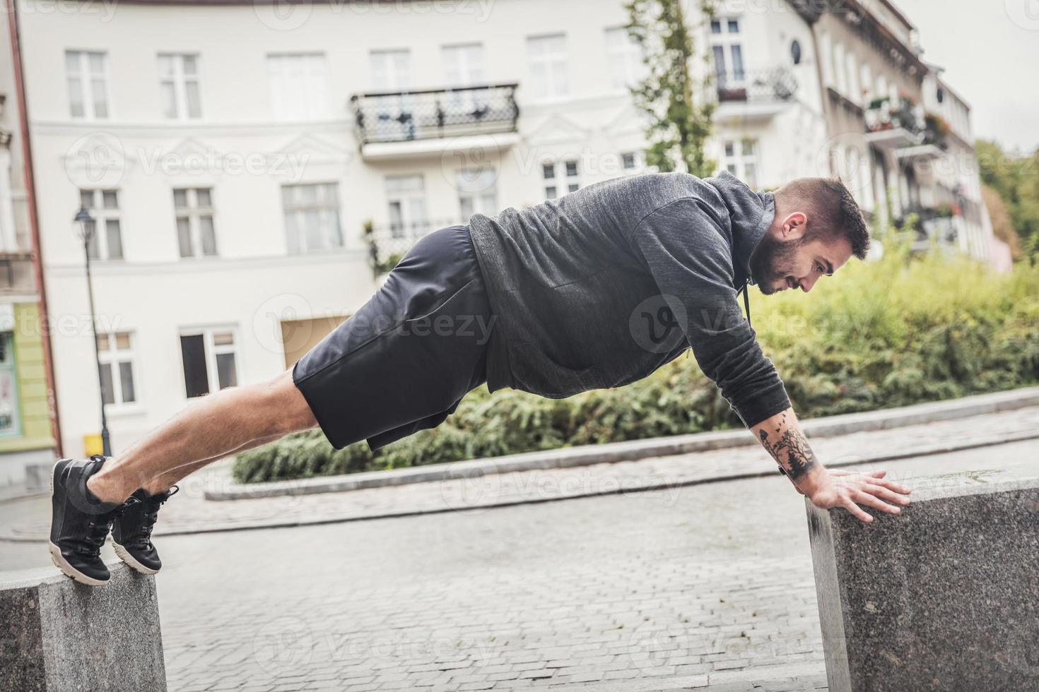 Athletic man training on a street. photo