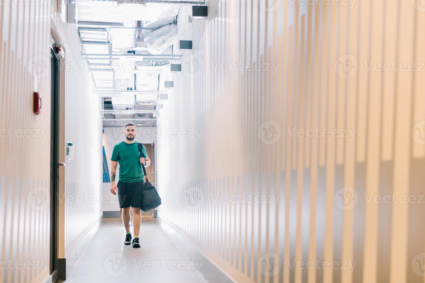 Fit man in a gym corridor. photo