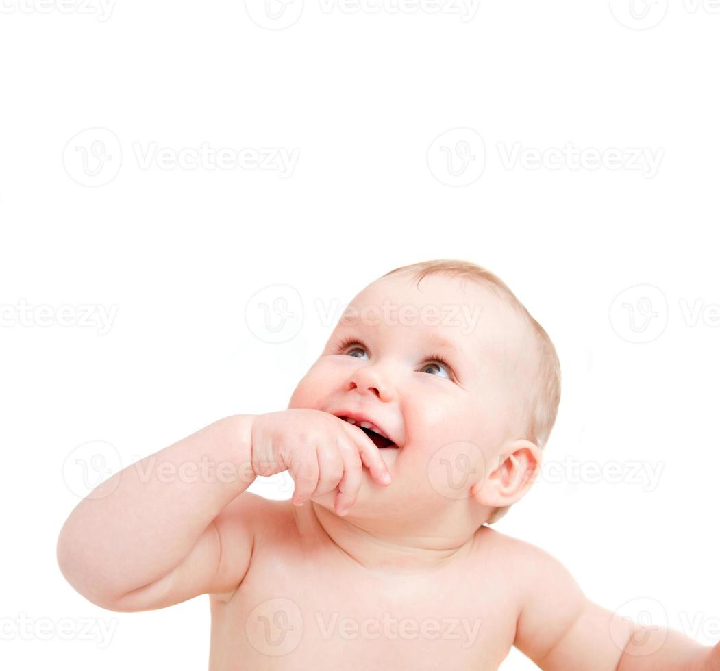 Cute happy baby smiling looking above on white photo