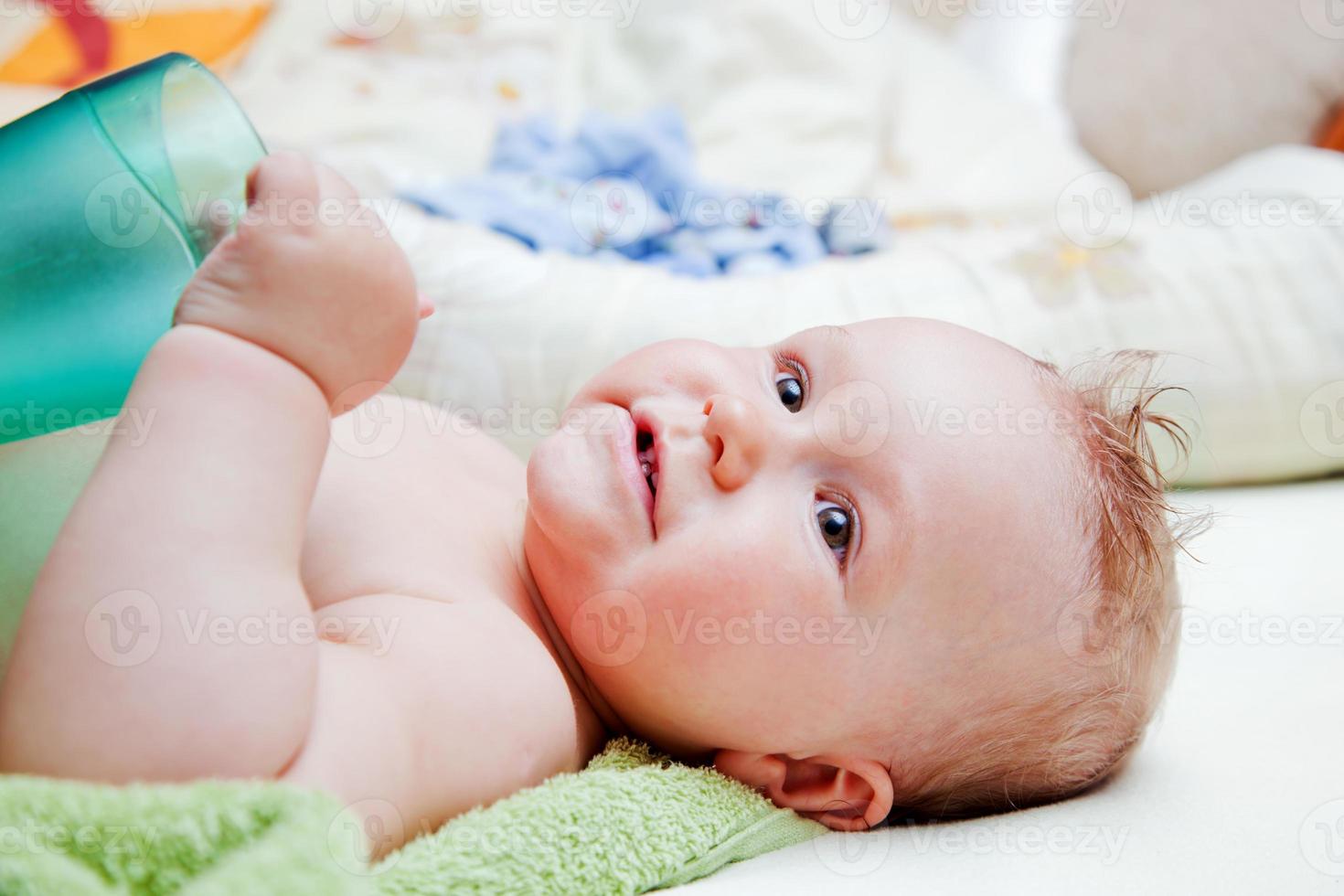 A baby waiting for changing his napkin photo