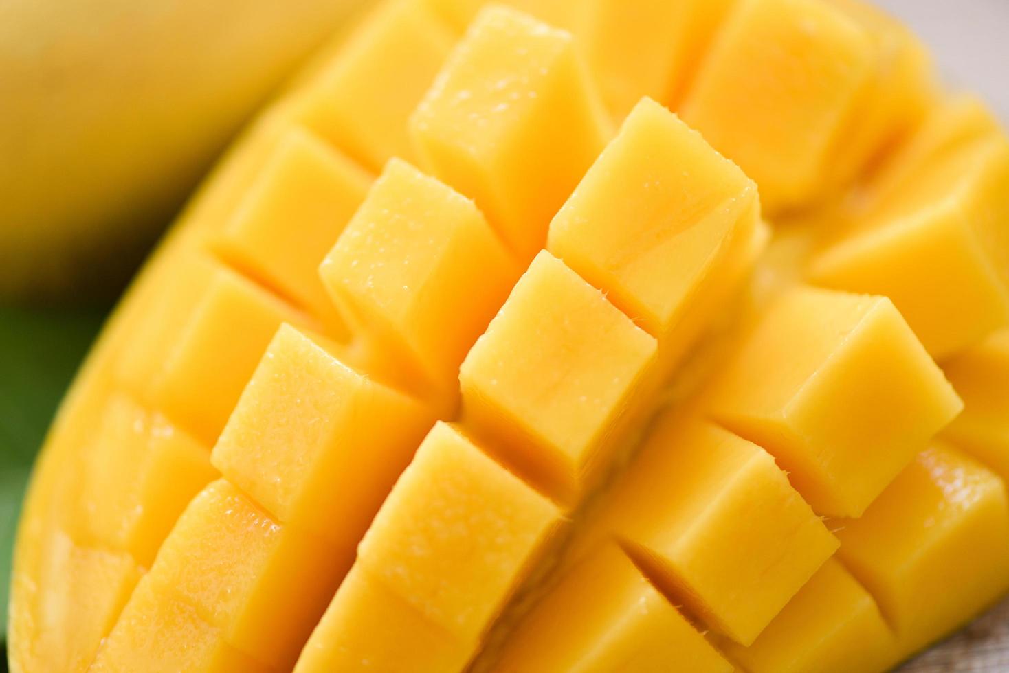 Mango slice and mango leaves from tree tropical summer fruit concept - Close up sweet ripe mangos cut photo