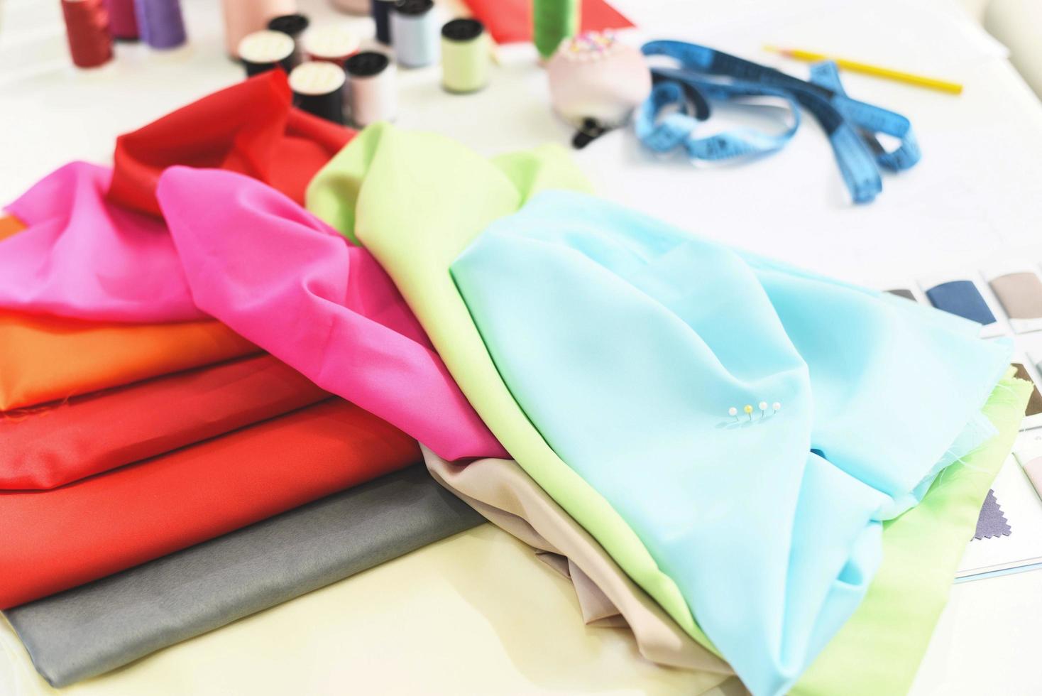 Tools handicraft Sewing thread and needle thread for fashion designer in studio textile material scissors cutting fabric clothes sewing machine designer working professional Colorful fabric cloth photo