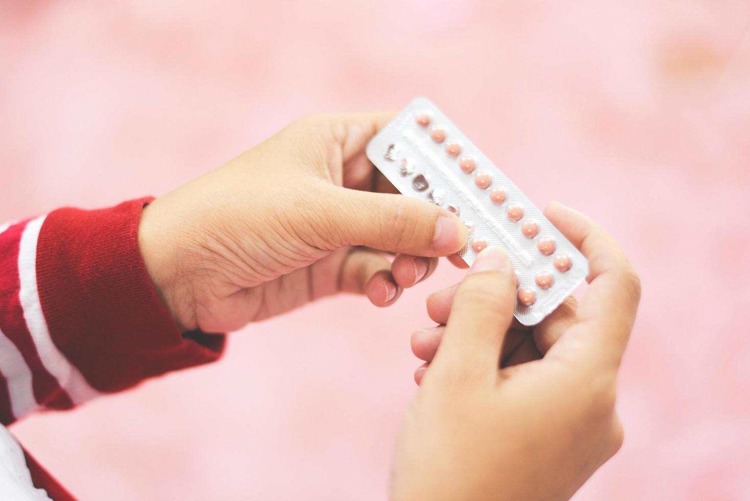 Contraception pills in hand woman holding - Birth control contraceptive means prevent pregnancy photo