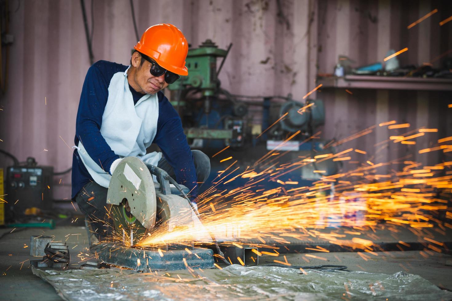 Cutting of a steel with splashes of sparks  in the industrial shop. photo