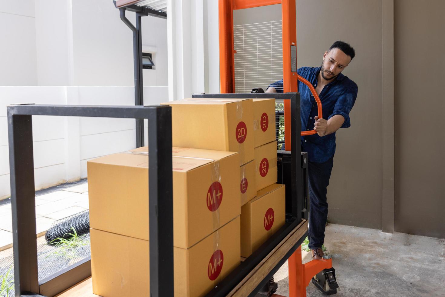 A man with carton boxes moving into new home. photo