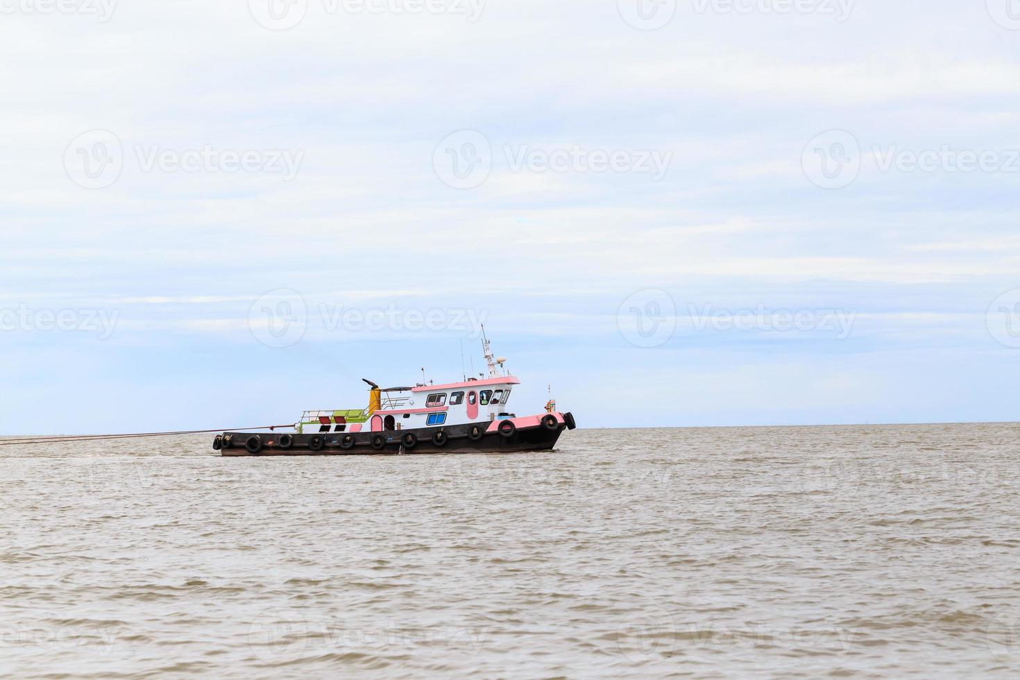 Pink tug boat was towed ship photo