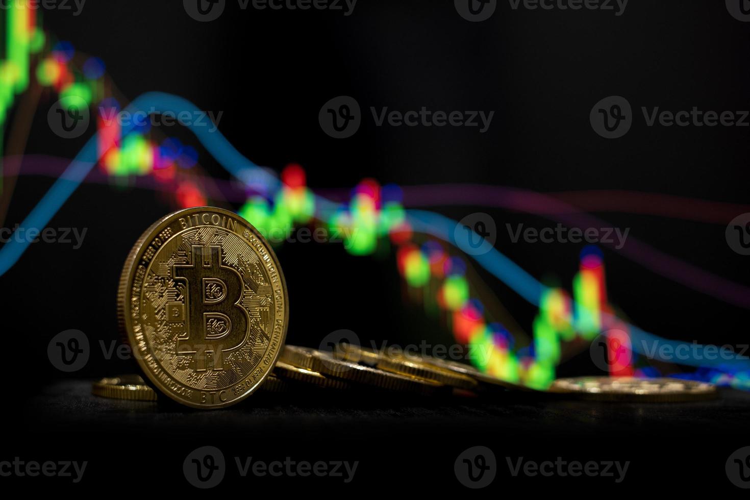 Golden bitcoin cryptocurrency at trading chart background photo