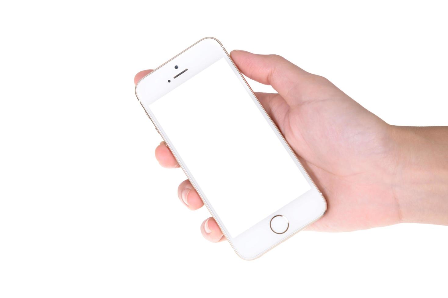 Woman hand showing a blank smart phone with isolated screens display on white background photo