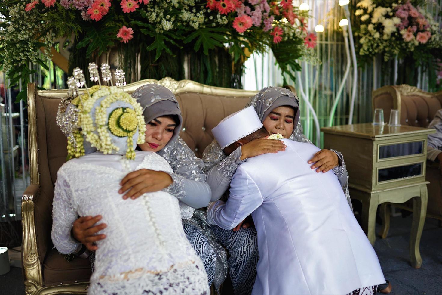 Bandung, West Java, Indonesia, 2021- Muslim groom and bride at the Sungkeman traditional Indonesian wedding ceremony photo
