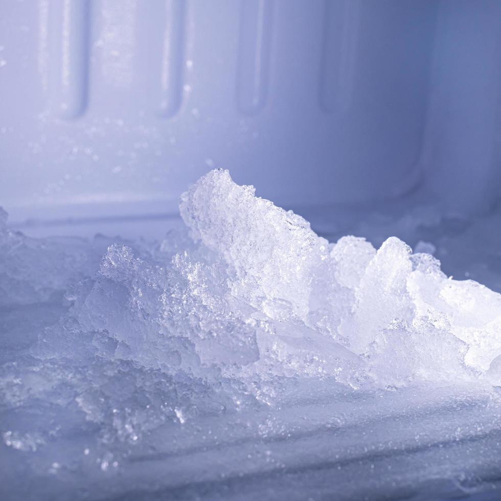 The freezer compartment of the refrigerator has a lot of ice on it. photo