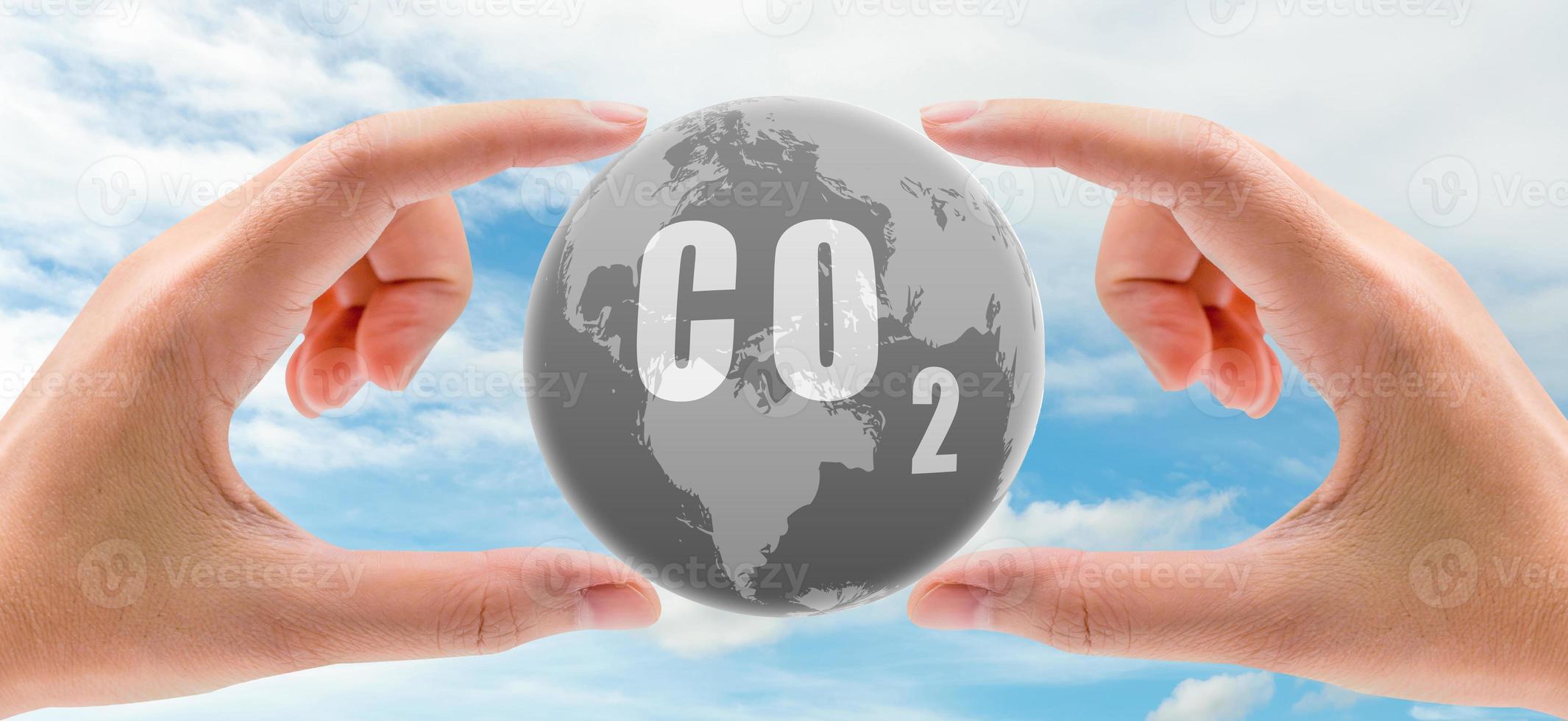 CO2 capture concept. Human hand holding CO2 in globe map on blue sky. Carbon capture and storage technology concept. Greenhouse gas. Carbon dioxide gas global air climate pollution. Environment issue. photo