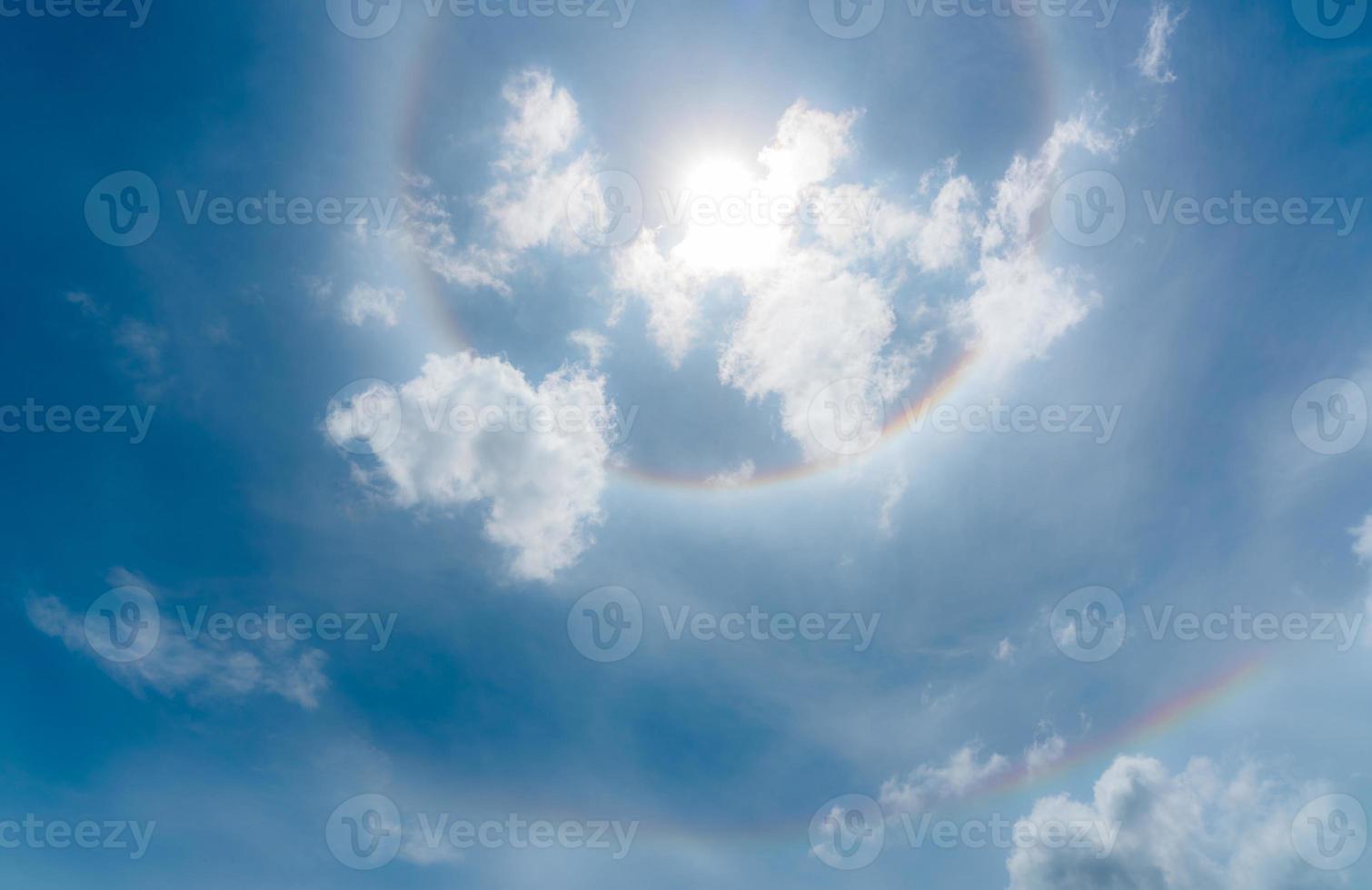 Sun Halo or a rainbow-colored ring around the sun. Sunny sky with sun halo. Optical phenomenon produced by light. Cirrus or cirrostratus clouds in the troposphere with light refraction and reflection. photo