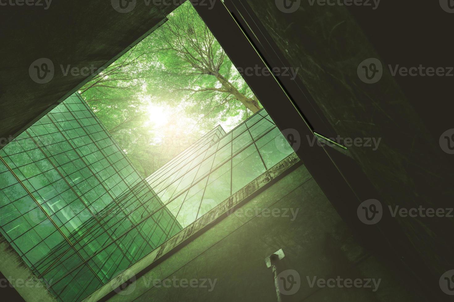 Eco-friendly building in the modern city. Sustainable glass office building with tree for reducing heat and carbon dioxide. Office building with green environment. Corporate building reduce CO2. photo