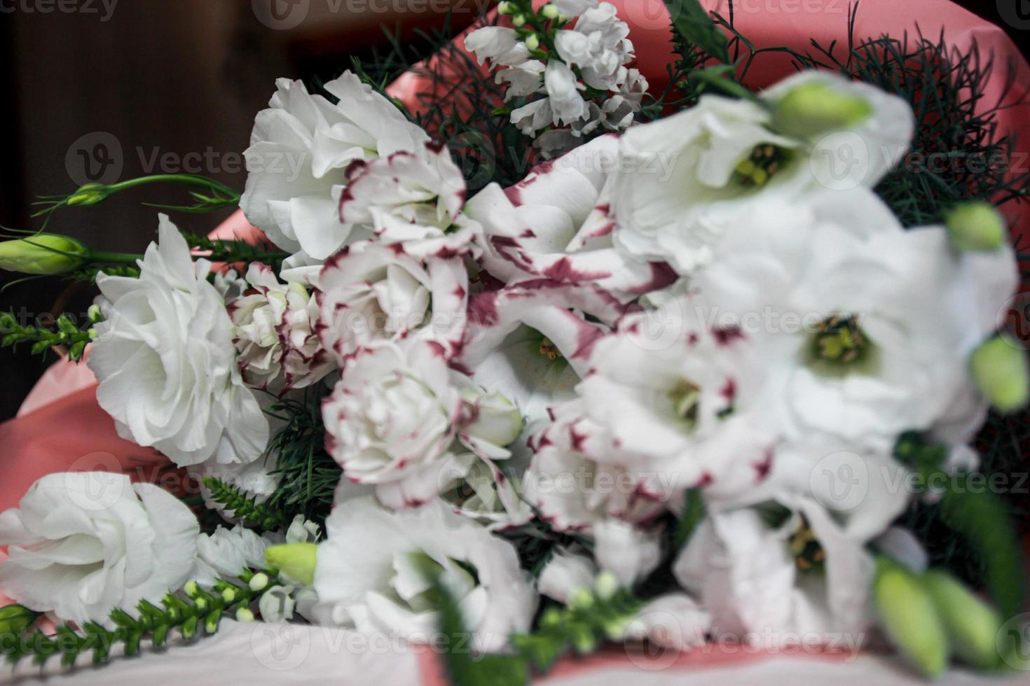 Festive white bouquet of flowers on a dark background, garland, pink color bouquet photo