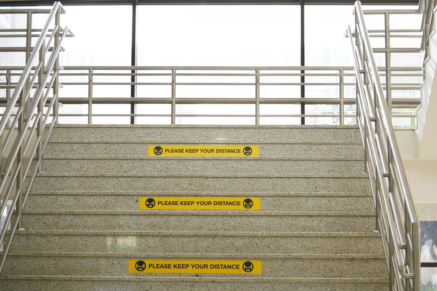 Please keep your distance label on the university stairs or building. real distance label.rectangle yellow labels. photo
