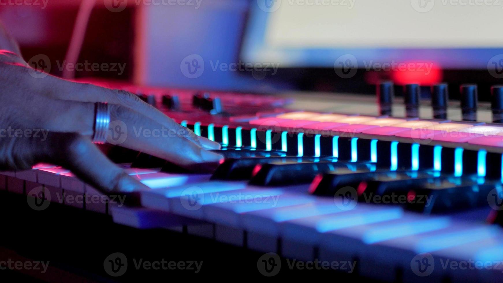 Fingers of a man who is playing synthesizer photo