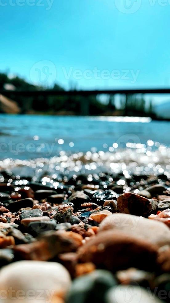 A background photo with a focus on stones of a lake shore