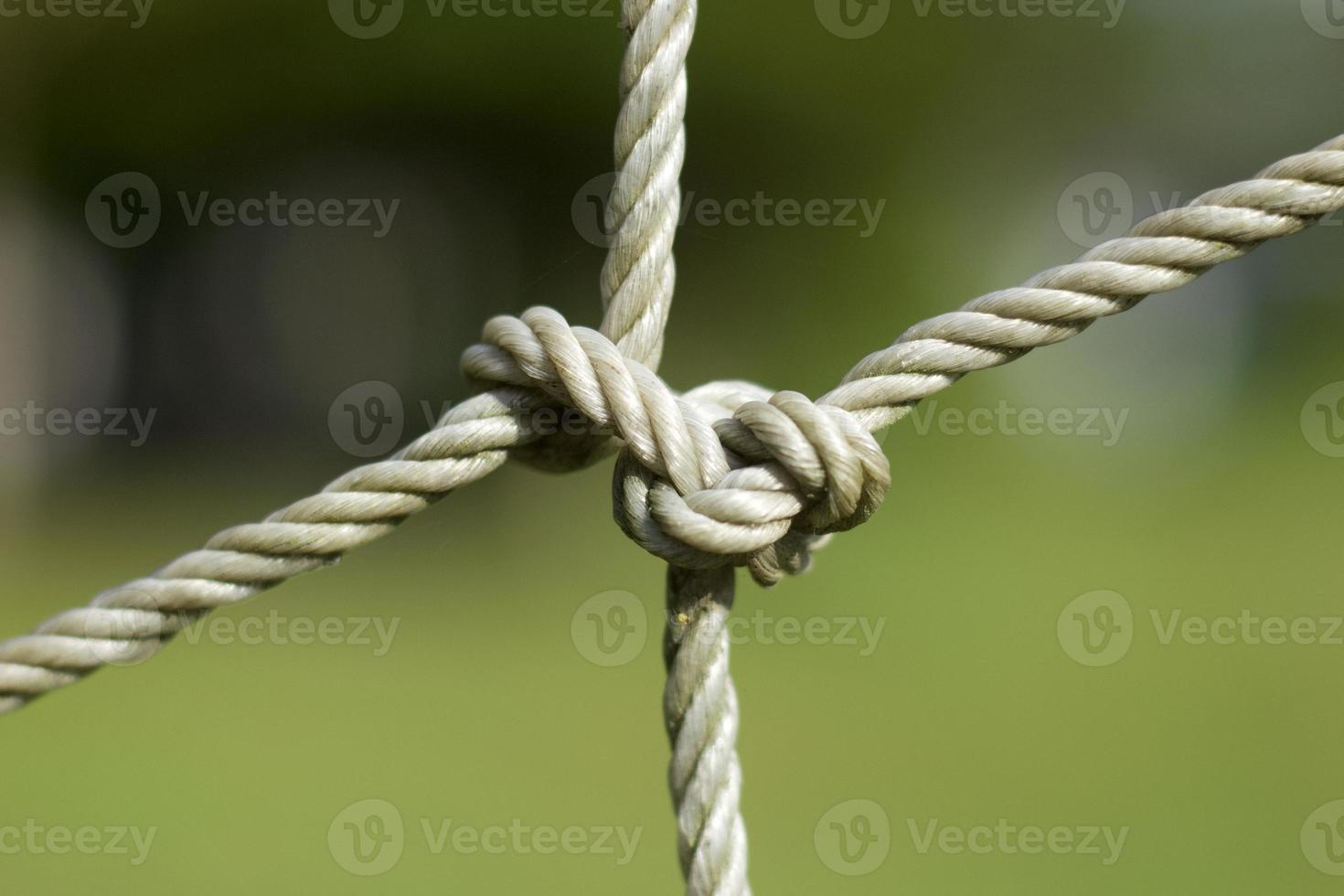 Focus and blur of soccer goal net in grass field, close up view. photo