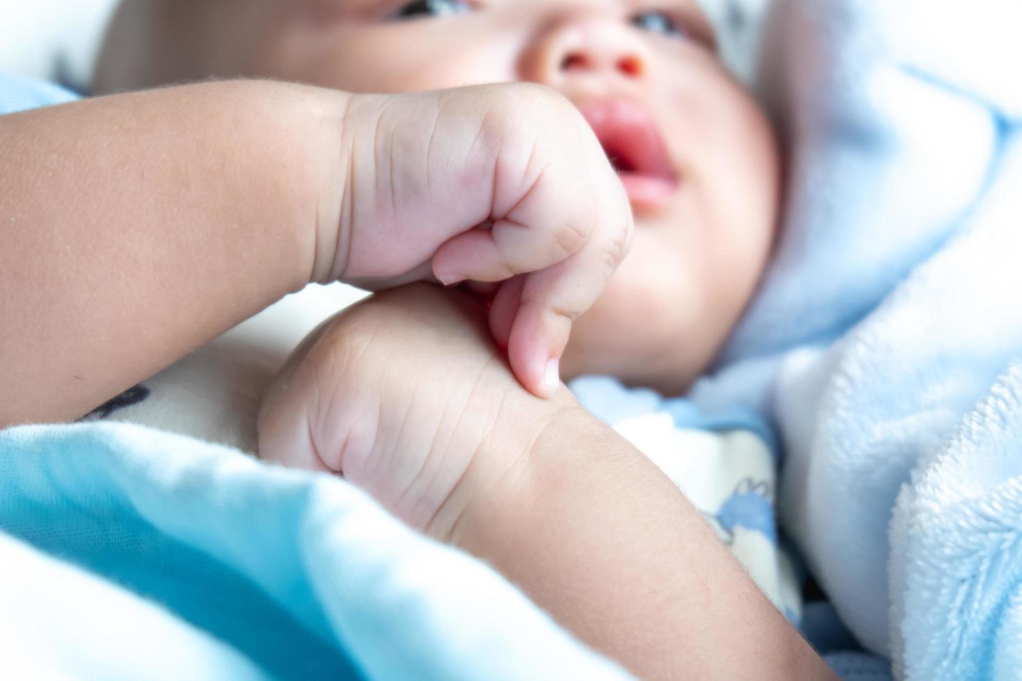 baby clenched on the bed photo