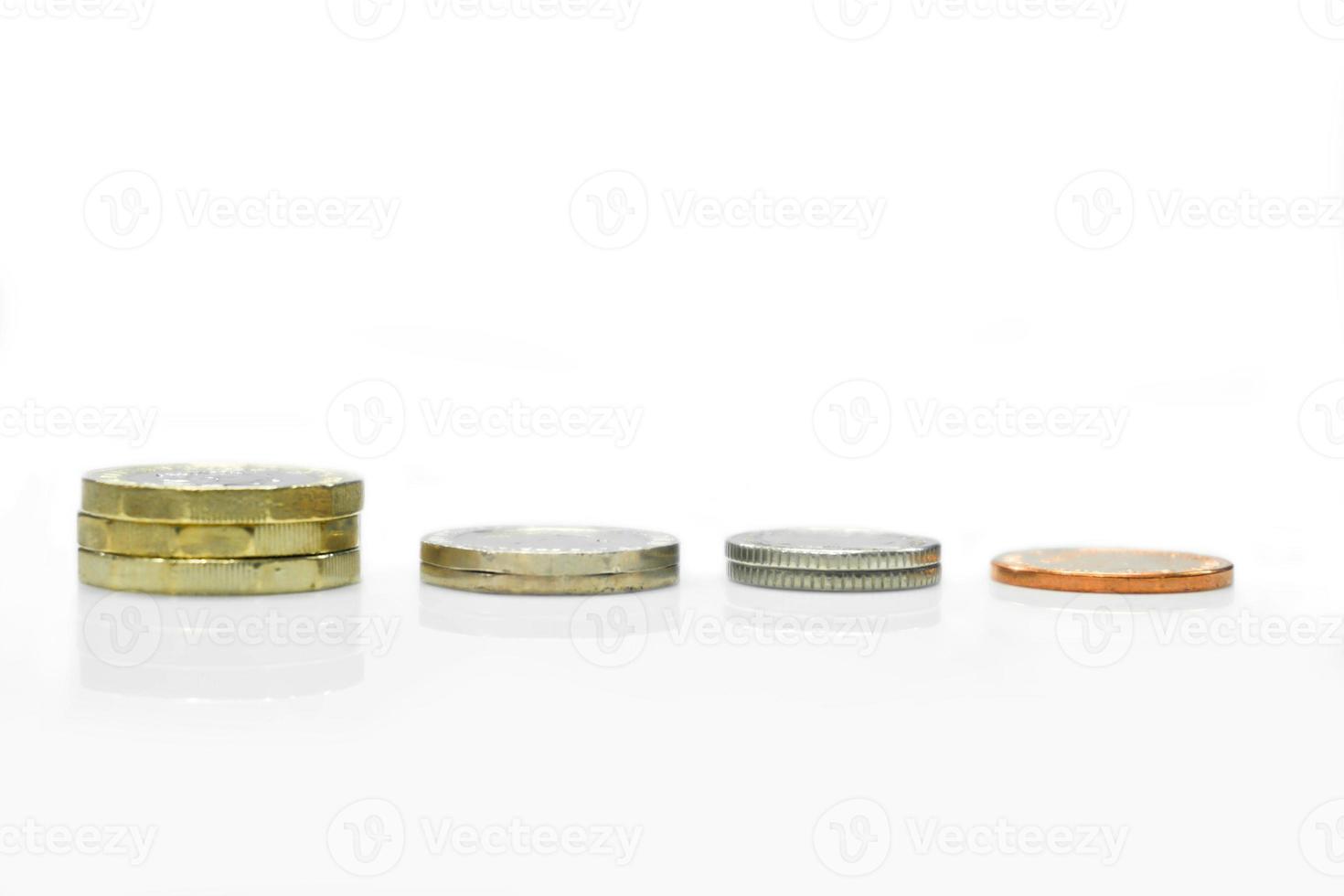 Side view and line up of British currency coins isolate on white background. Coin line up is like the economy of the country. photo