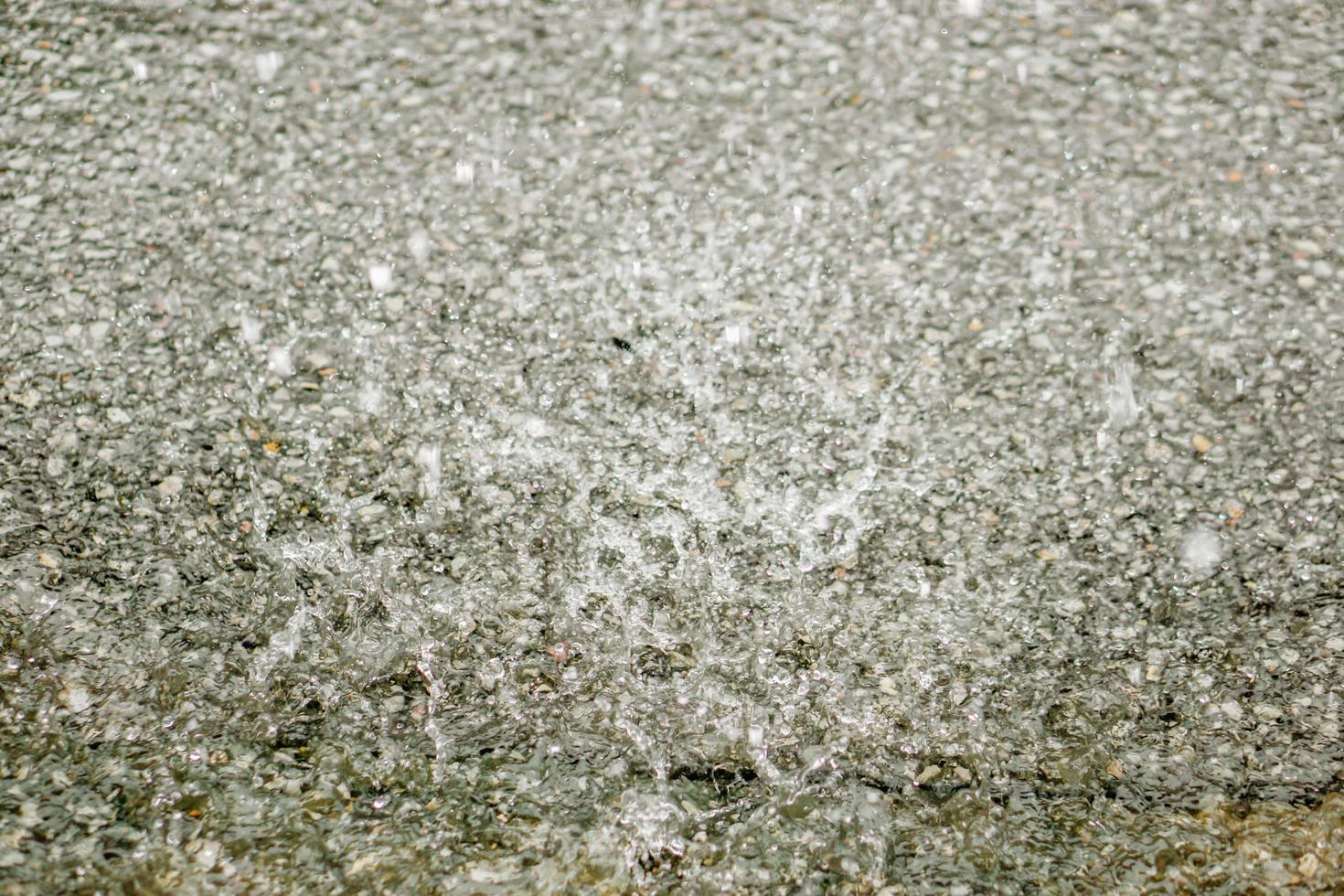 Background and texture of torrential rain drop on the road. photo