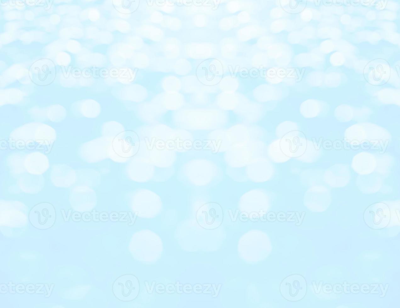 Abstract blurred and bokeh of droplets and reflection lighting on light blue background. photo