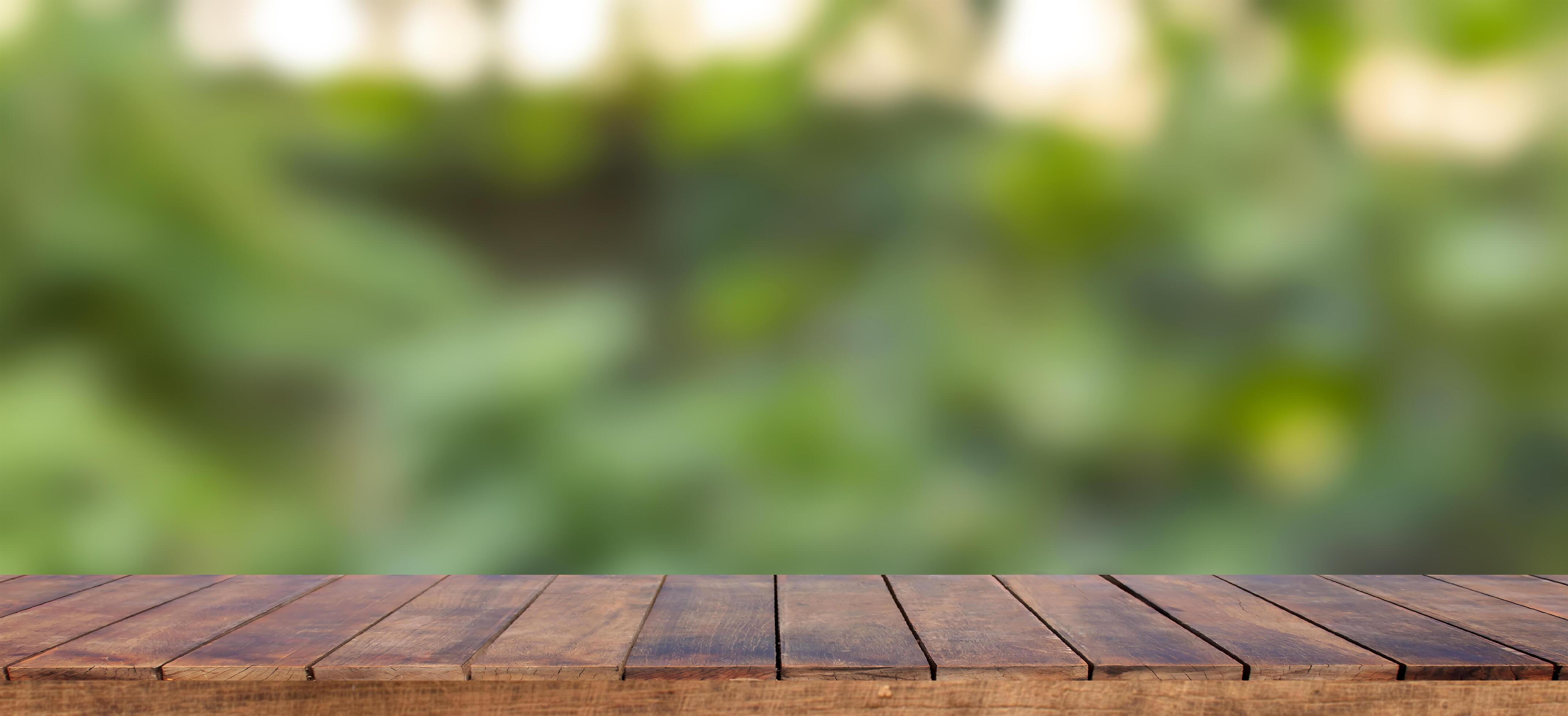 Empty wooden table background and blurry green background on the  agricultural farm. Background ideas can be used for displaying or editing  your products. 9375831 Stock Photo at Vecteezy