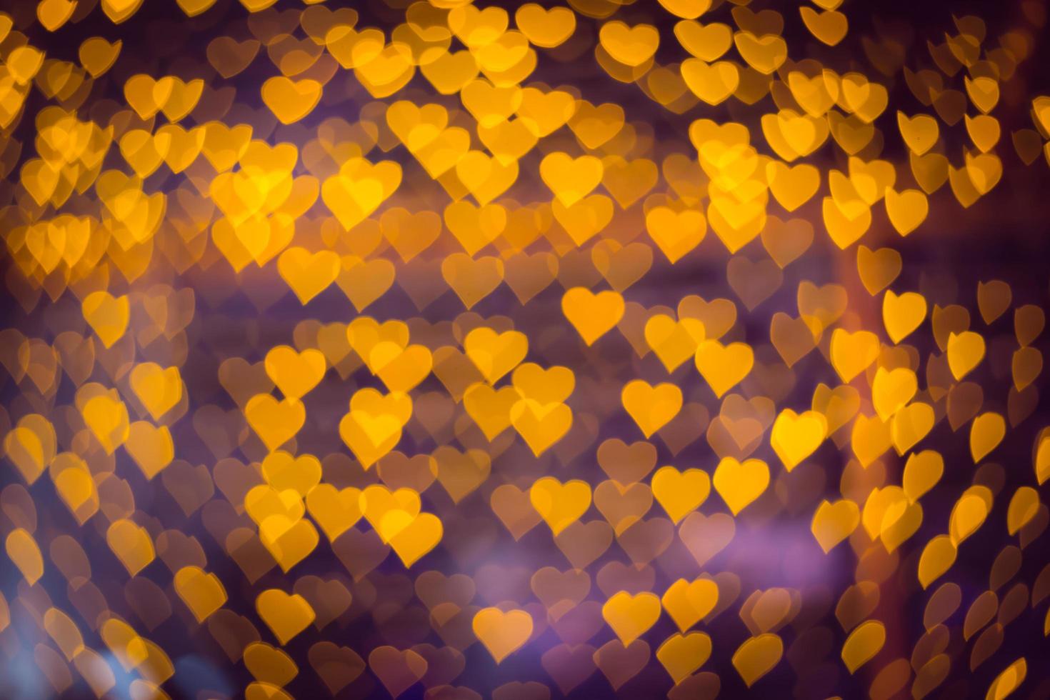 Abstract many yellow heart bokeh background for christmas or happy new year and valentine's day light festival. Soft focus photo