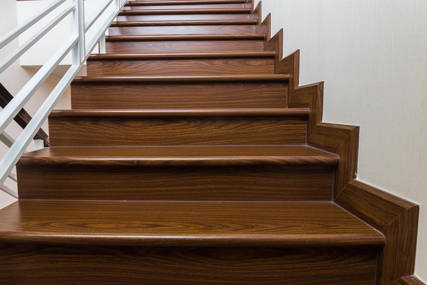 Staircase custom built home interior with wood staircase and white walls. photo