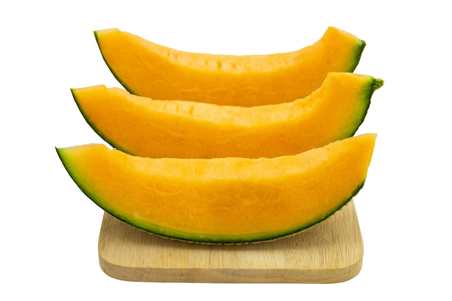 Closeup melon bright colors that is pieces on wooden tray isolated on white background. clipping path photo