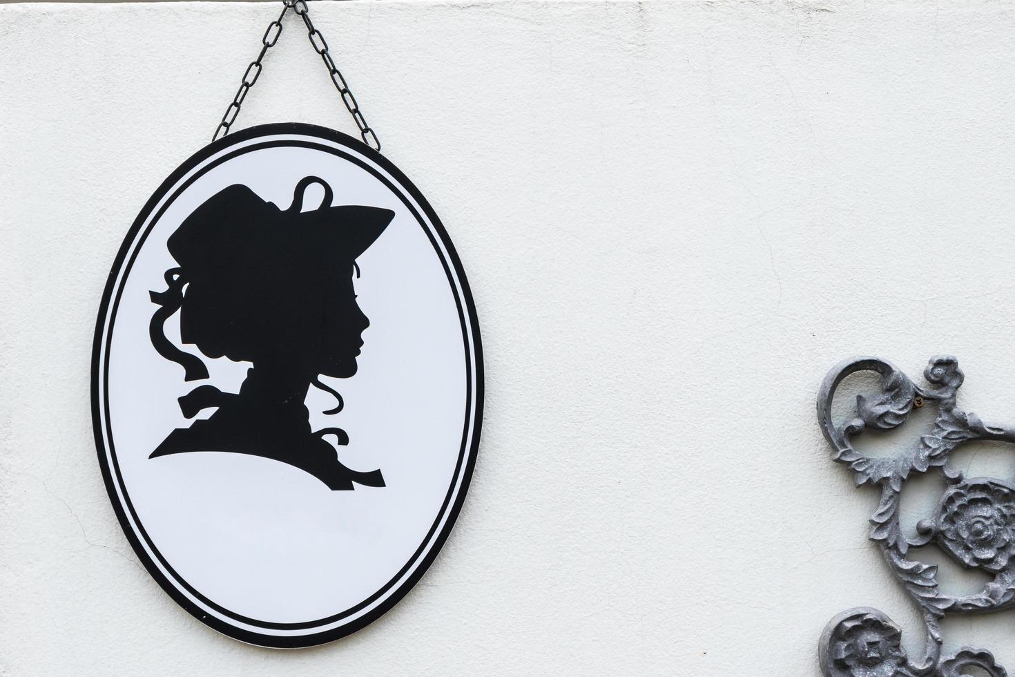 Toilet sign in vintage or classic style lady or woman symbol on wall WC. photo