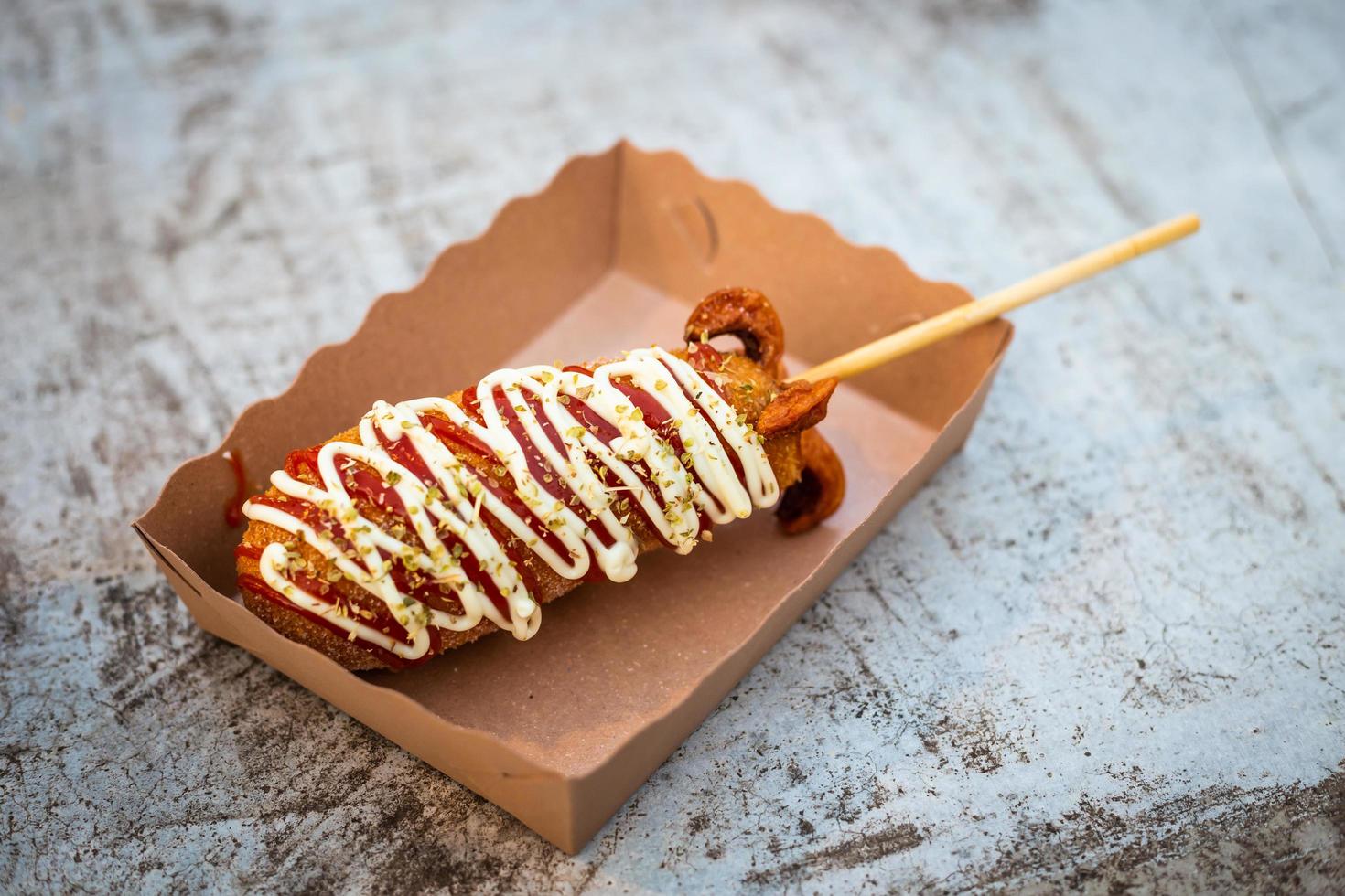 Mozzarella cheese stick sausages in paper cup on table ready to eat. photo