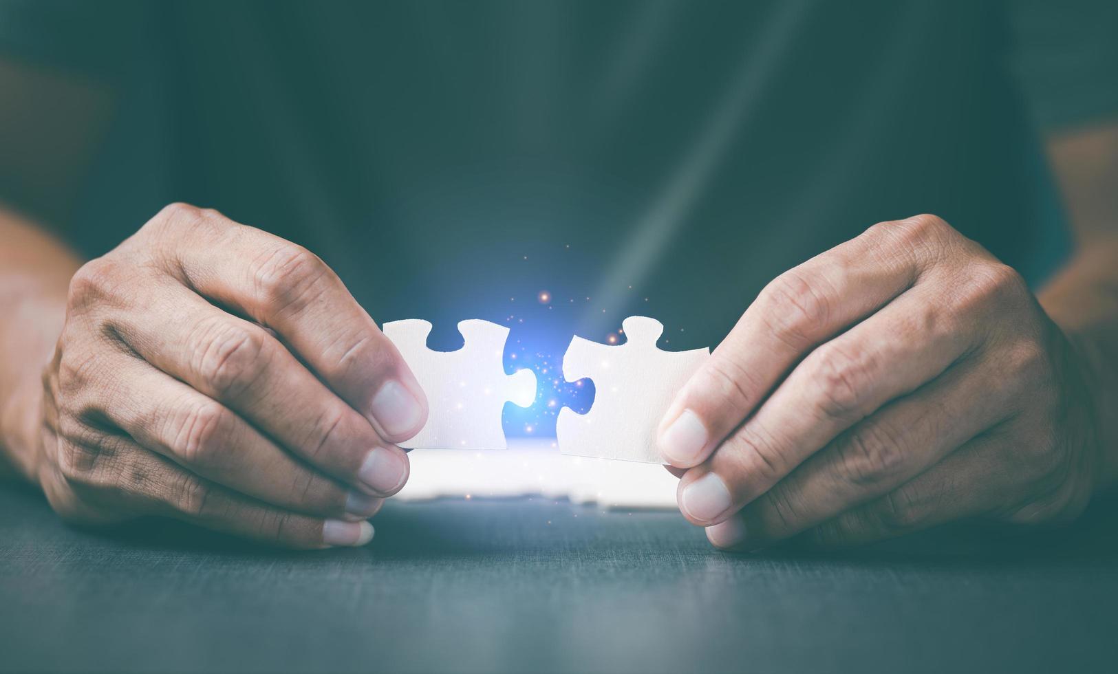 jigsaw puzzle in the hands of a young businessman, photo