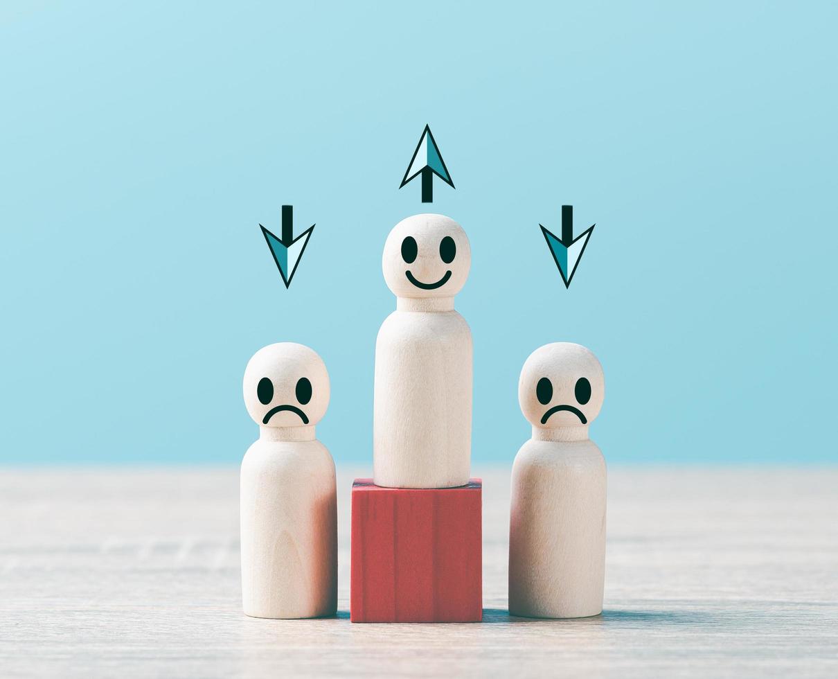 Wooden dolls lined up on a wooden table. photo