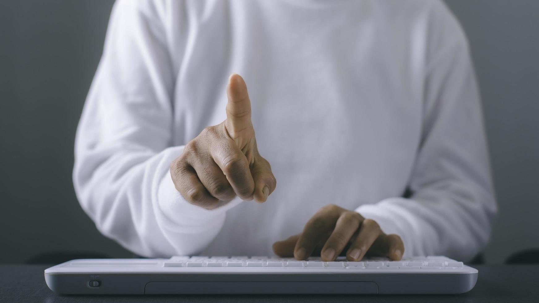 Young woman working in front of the computer on the desk photo